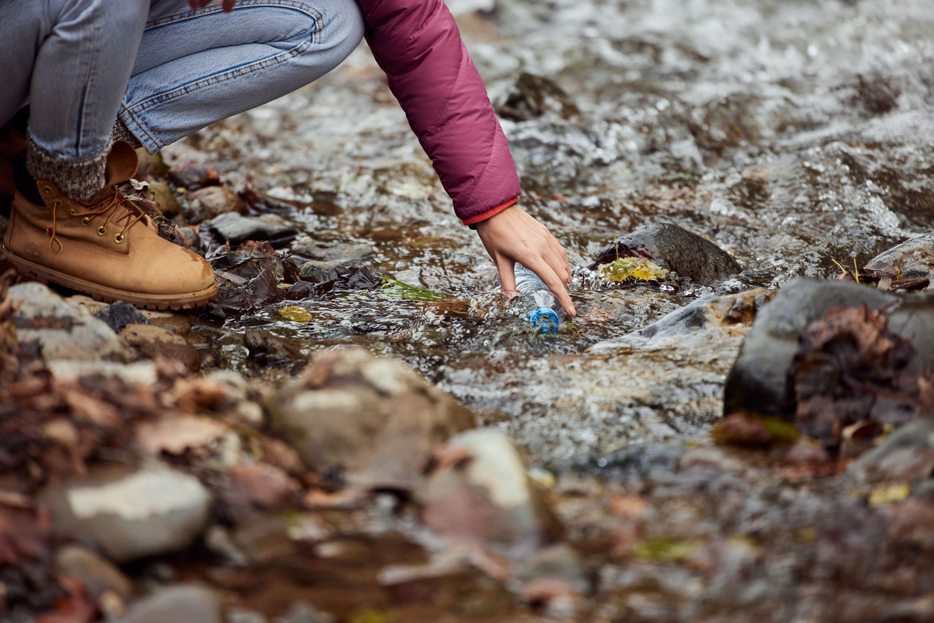 person-collecting-litter-from-stream-in-nature-con-2025-09-09-20-16-53-utc